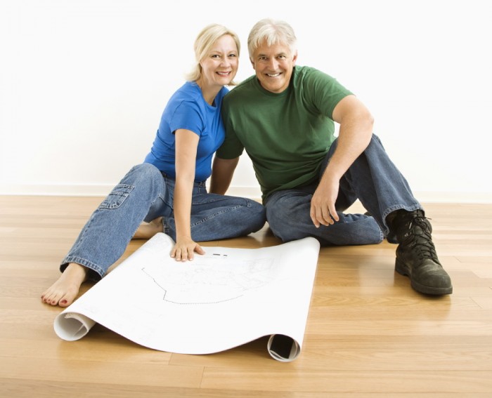 Man and woman with blueprints.